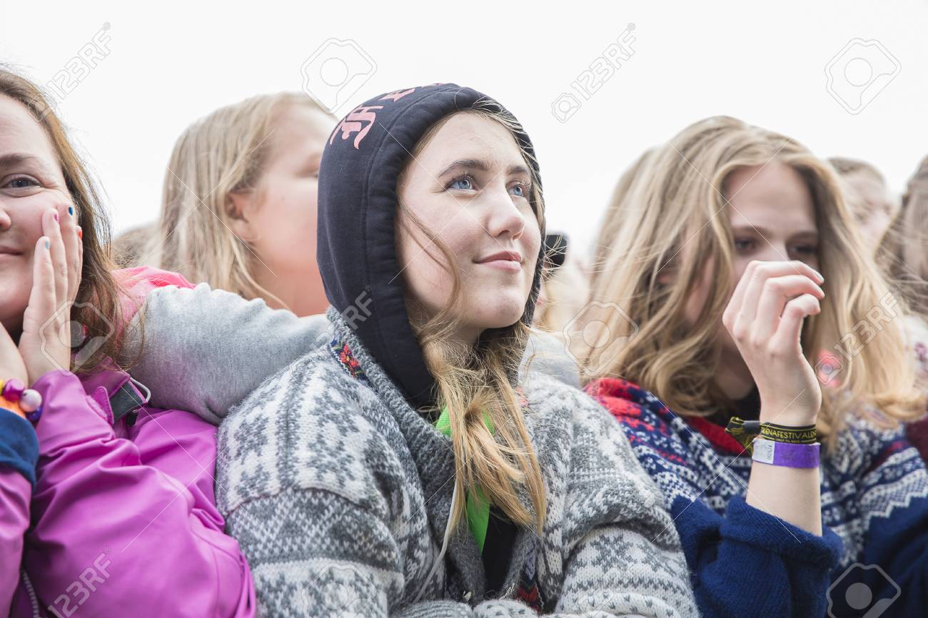Admirative girl in the audience under the rain during concert of Norwegian  pop singer Aurora at