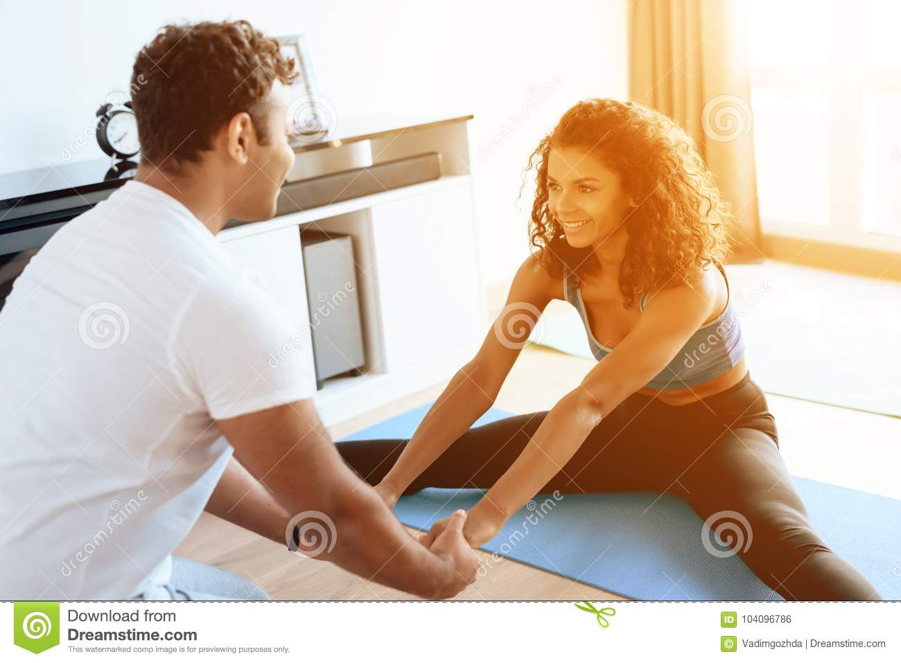 Download Aframerican Couple Doing Yoga Exercises At Home. They Sit On The  Floor On Mats