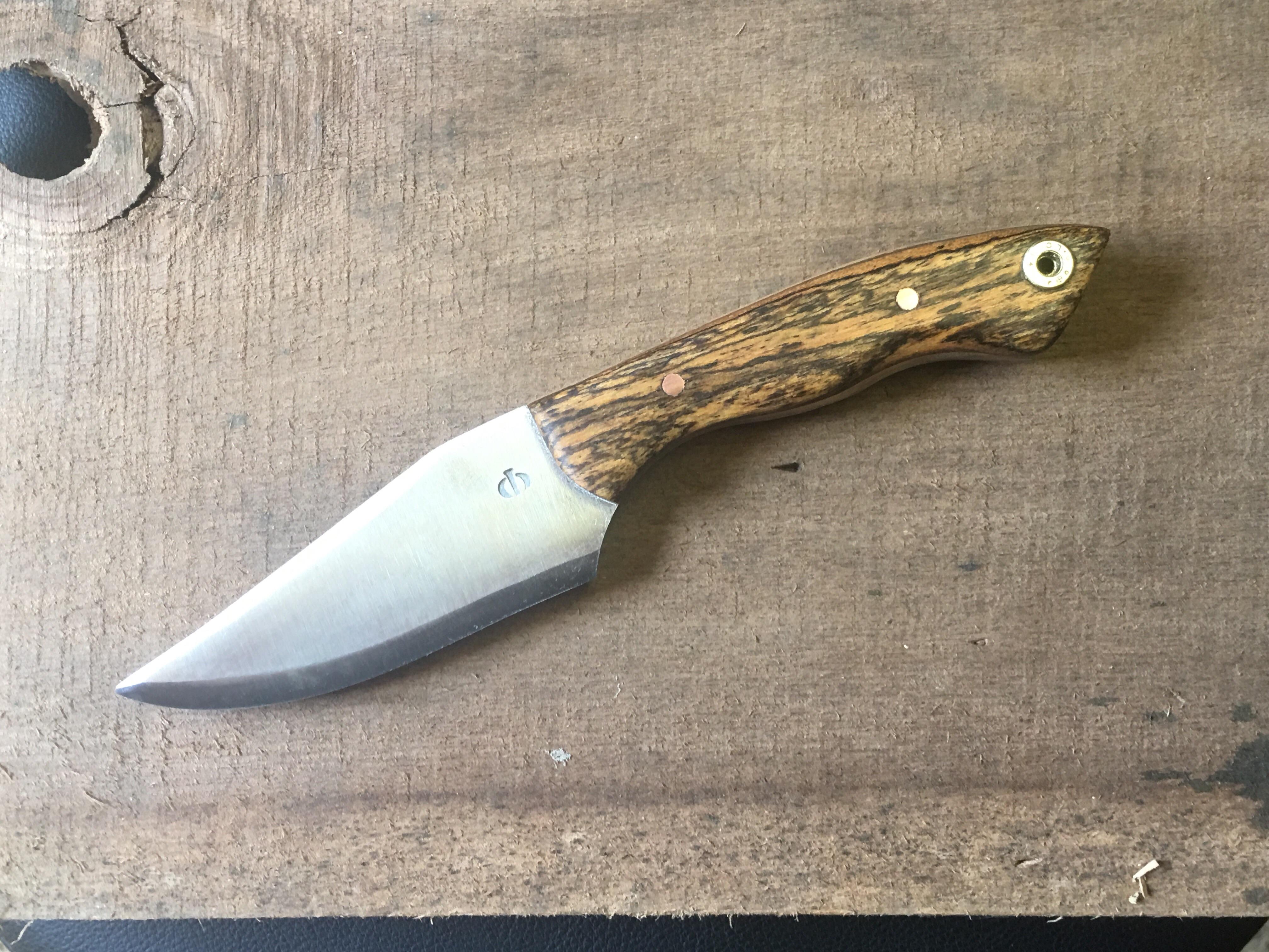 Newest knife out of the forge. Reclaimed tool steel with bocote handle,  brass pins and 5.56 casing lanyard pin