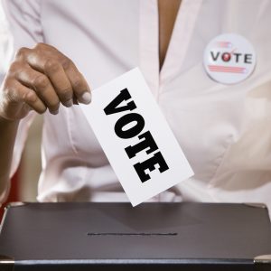 Woman casting ballot in voting box
