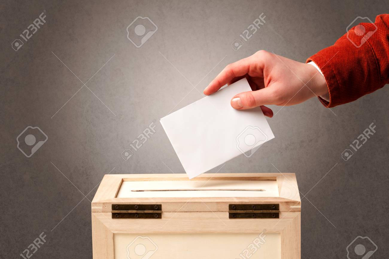 Ballot box with person casting vote on blank voting slip, grungy background  Stock Photo -