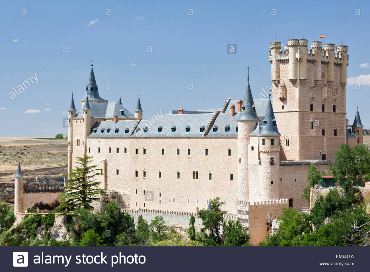 An exterior view of a large castle like building called Alcazar of Segovia,  seen from