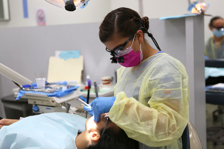 Female dental hygenist working on a patient