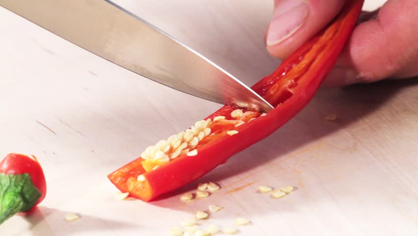 A chili pepper being deseeded