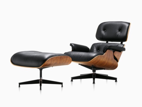 Black leather Eames Lounge Chair and Ottoman with a wood veneer shell,  viewed from a