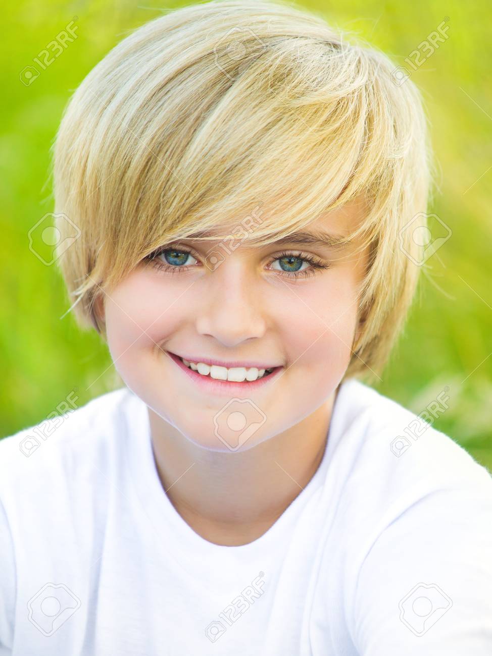 Portrait of fair-haired boy looking at camera outdoors Stock Photo -  74262231
