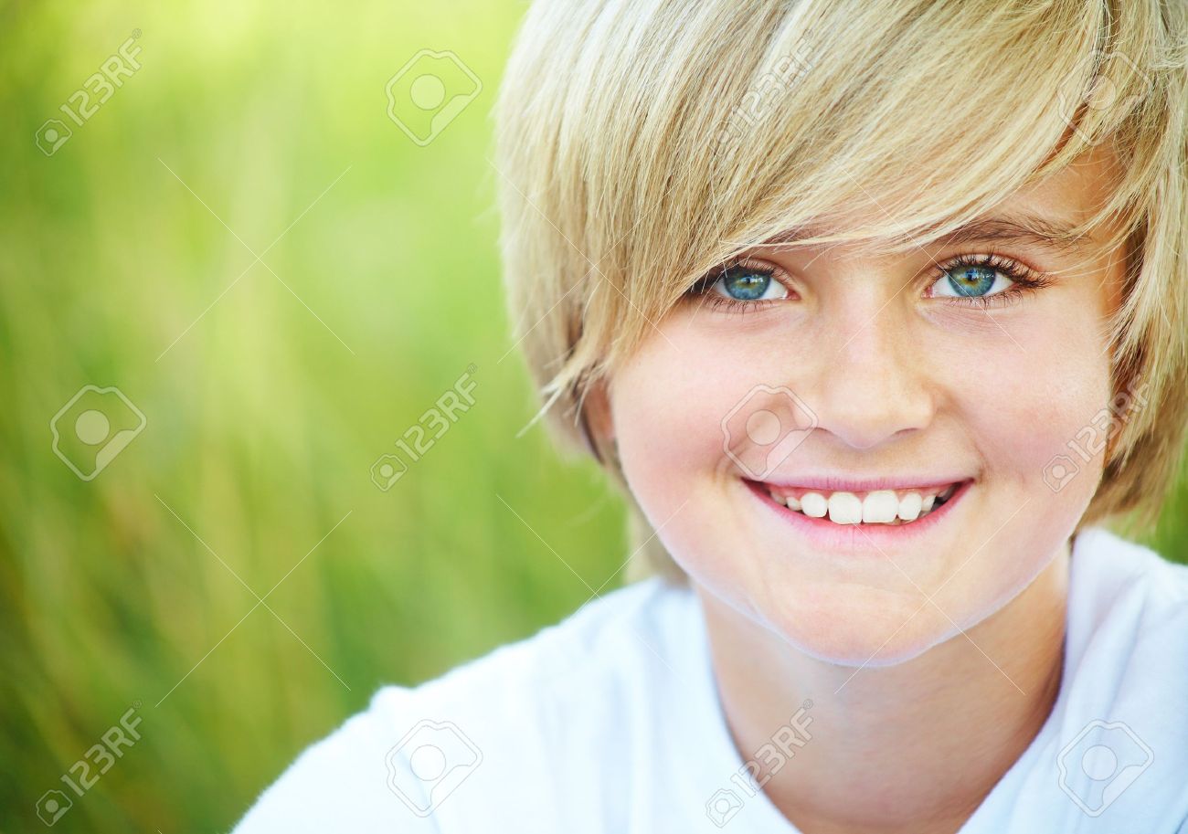 Portrait of fair-haired boy looking at camera outdoors Stock Photo -  10430562