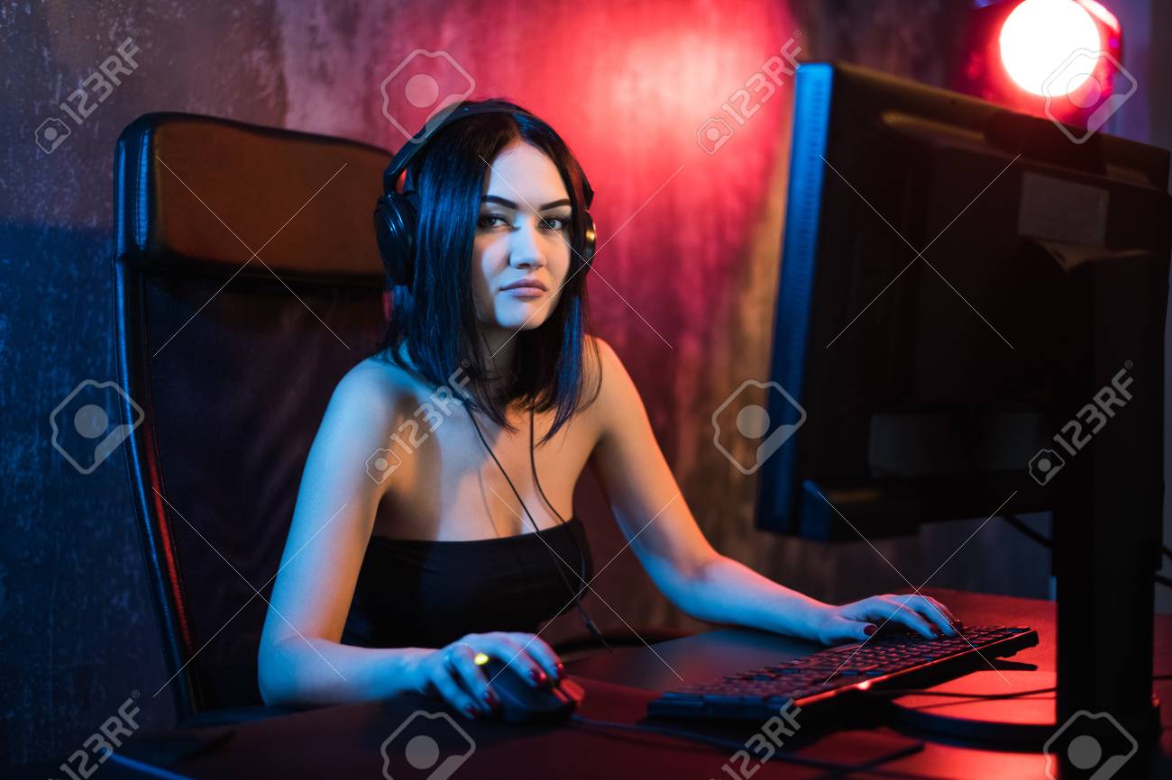 Beautiful Professional Gamer Girl Playing in First-Person Shooter Online  Video Game on Her Personal