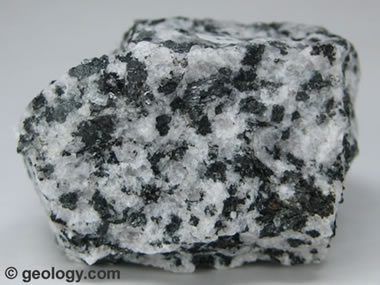 Diorite is a coarse-grained, intrusive igneous rock that contains a mixture  of feldspar, pyroxene, hornblende, and sometimes quartz.