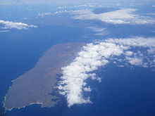 Aerial photo of Kahoʻolawe. In the background is Mount Haleakala on Maui.